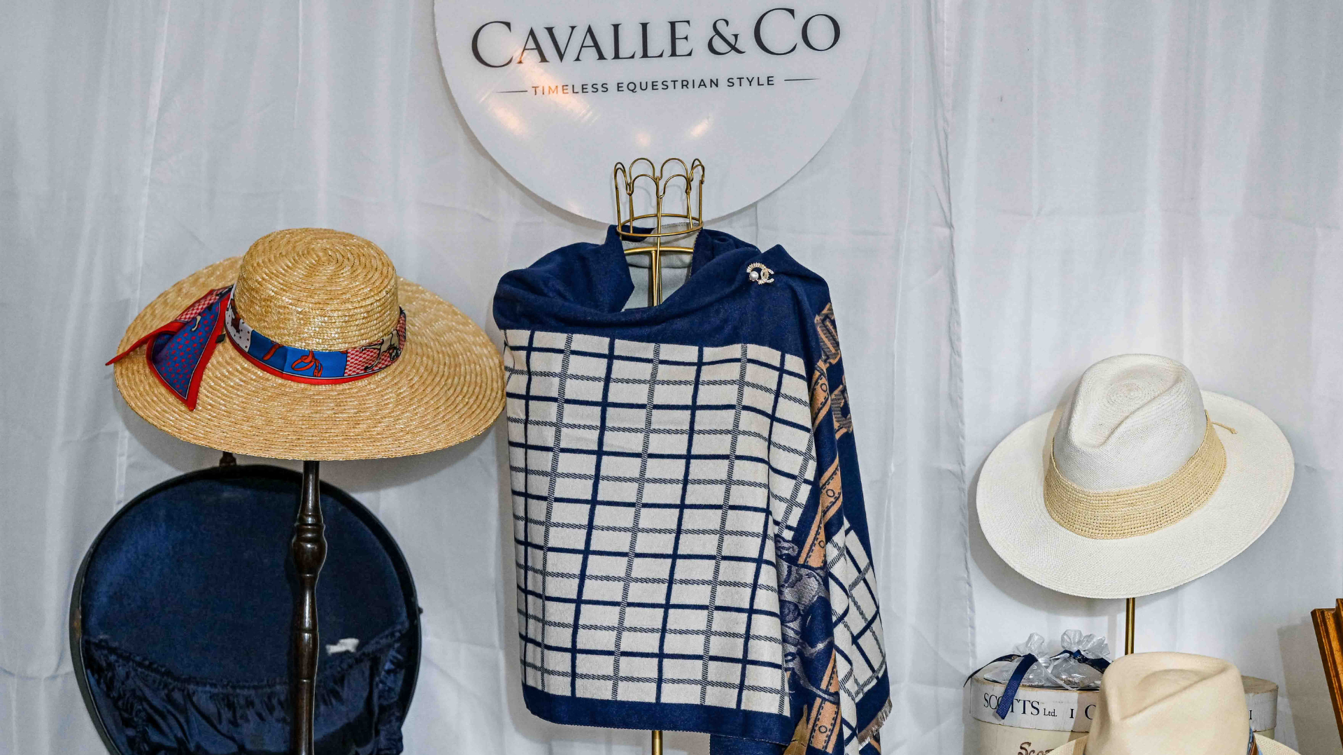Equestrian print silk shirt on mannequin with fedora hats at Grand Nationals